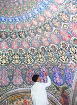 A worker of the science department of the Archeological Survey of India (ASI) does restoration work at Jhanda Sahib in Dehradun.