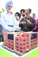 Punjab police DGP N.P.S. Aulakh (left) looks at the model of cyber crime police station and forensic science lab in Mohali 