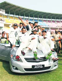 The Indian cricket team celebrates during a victory lap after winning the fourth Test against Australia