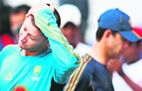 Michael Clarke (L) reacts as captain Ricky Ponting walks past during the presentation ceremony