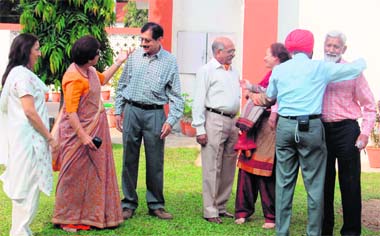 THAT must BE YOU! Batchmates of 1958, St Thomas School, Dehradun, exchange notes at their reunion on Wednesday. Tribune photos: Anil P. Rawat
