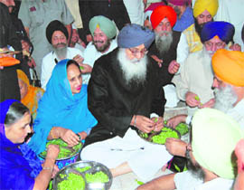 Chief Minister Parkash Singh Badal and his wife Surinder Kaur perform langar sewa at the Golden Temple complex in Amritsar on the eve of Guru Nanak Dev’s birth anniversary on Wednesday.