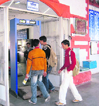 Persons pass through a metal detector at the railway station where no cop was present on Thursday.