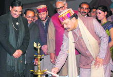 Uttarakhand Chief Minister B.C. Khanduri lights a lamp to inaugurate a cultural evening at Pragati Maidan, New Delhi, on Wednesday.
