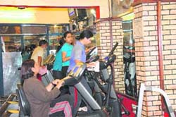 Women work out in a gym.