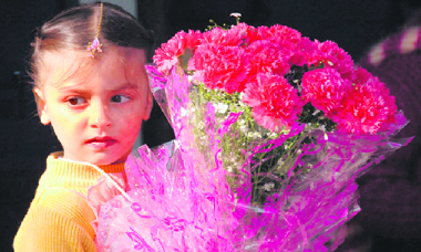 A student of Doon Blossom School waits for the chief guest at the annual function.