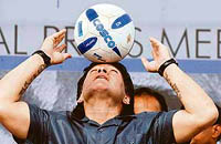 Diego Maradona heads a football in Kolkata.