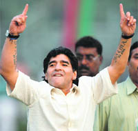 Maradona gestures towards fans while attending an event at the Mohun Bagan club, in Kolkata on Sunday.