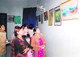 People view items on display at the art exhibition being held at Delhi Public School in Haridwar