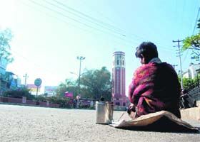 A beggar on the deserted Rajpur road during the bandh in Dehradun
