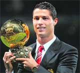 Manchester United's Cristiano Ronaldo poses with the Ballon D'or trophy in Manchester 