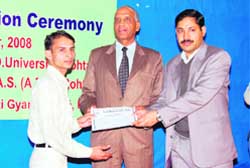Rohtak ADC P.C. Meena honours a young innovator, Chand Singh, at a function in Rohtak.