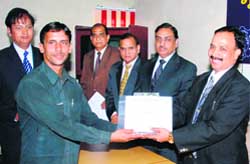 Dr A.K. Srivastava, director, NDRI, presents a certificate and memento to a former NDRI trainee in Karnal