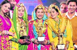 Mohit Inder (centre) of Chandigarh, who won the Ms World Punjaban contest, is flanked by first runner-up Gurpreet Kaur from Canada and second runner-up Supreet Malli from the US at a function at the PAP Grounds in Jalandhar