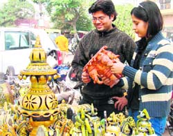 People buy handicraft items at an exhibition in Haridwar on Monday.