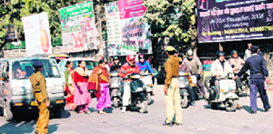 Policemen regulate traffic at Panchayati Chowk, near Clock Tower, in Dehradun on Saturday.