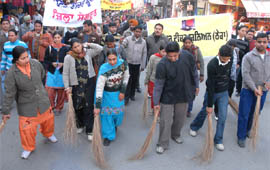 Computer teachers from the Malwa region sweeping the roads with brooms to stage a protest in Bathinda on Monday.