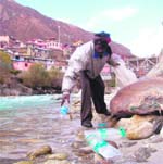 plastic bottles being collected from a stream near Badrinath.