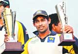 Tillakaratne Dilshan holds up his Man of the Match and Man of the Series trophies after Sri Lanka routed Bangladesh in Chittagong Test 
