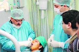 Dr Ashwani Dobhal performs a dental implant in Dehradun on Monday. 