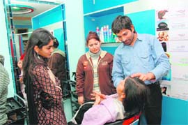 A woman gets hair treatment at a salon in Dehradun. 