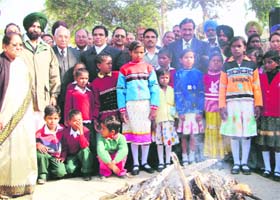 Santosh PD Chowdhry (extreme left), manager of Arya Anathalaya, and others celebrate Lohri along with inmates of the orphanage at Ferozepur