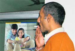 A man smokes at a public place in Hamirpur. 