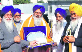 Dr Jagtar Singh Bhatti, a Canadian resident, being felicitated by Avtar Singh, SGPC president, in Amritsar on Tuesday. Giani Gurbachan Singh, Jathedar, Akal Takht, Giani Balwant Singh Nandgarh, Jathedar, Takht Damdama Sahib, can also be seen in the picture.