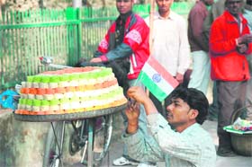 A vendor sells sweets arranged in the colours of the Tricolour on Republic Day in Dehradun