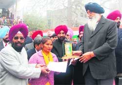 Master Ajit Singh and Satpal Kaur receive award from CM Parkash Singh Badal in Amritsar 