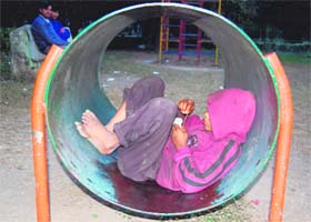 A street urchin finds refuge from the big bad world inside a play tunnel at Gandhi Park in Dehradun