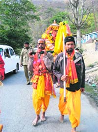 Devotees carry the deity in palanquin