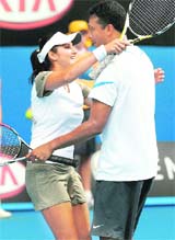 India's Mahesh Bhupathi and Sania Mirza celebrate winning the mixed doubles final match against Israel's Andy Ram and France's Nathalie Dechy at the Australian Open in Melbourne on Sunday. 