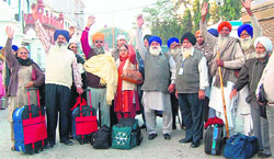 Sikh devotees outside the SGPC information office on the Golden Temple premises before leaving for Nankana Sahib, Pakistan, to observe the Nankana Sahib tragedy, in Amritsar on Monday.