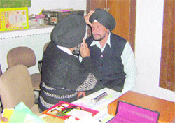 A patient is being examined at an eye camp in a Kapurthala village.