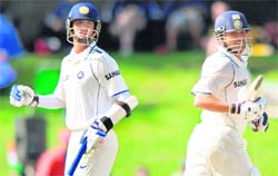 Rahul Dravid (L) and Sachin Tendulkar cross each other as they complete a run during the second day of the first Test match between India and New Zealand at Seddon Park Stadium in Hamilton on Thursday. India were 278 for 4, one run behind New Zealand's first innings 279 at stumps.