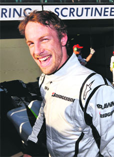 Brawn driver Jenson Button celebrates after claiming pole position in qualifying for the Australian Grand Prix in Melbourne on Saturday. � AFP