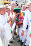 Cong candidate from Anandpur Sahib Ravneet Singh Bittu bows to touch feet of an elderly person at Haibowal village, Garhshankar,