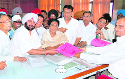 Congress candidate Santosh Chaudhary, along with Capt Amarinder Singh, files nomination papers at Hoshiarpur on Tuesday. 