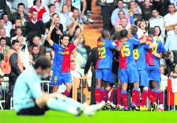 Barcelona players celebrate after beating Real Madrid in the La Liga on Sunday.