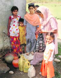 Residents of Nainwan village in Garhshankar queue up to fill water from a common tap