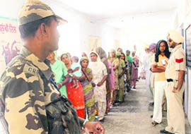 A CRPF jawan keeps vigil at one of the polling stations in the Sangrur constituency