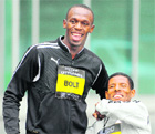 Sprinter Usain Bolt (L) and distance runner Haile Gebrselassie in Manchester on Friday.