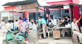 People, in the absence of any sitting arrangement, stand in front of a courtroom in the judicial complex, Pathankot.