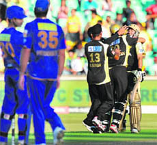 Ajit Agarkar (C) of Kolkata Knight Riders is hugged by teammates to celebrate their win over Rajasthan Royals in Durban on Wednesday.