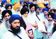 Dal Khalsa activists give memorandum to SGPC officials during their march to commemorate the 25th anniversary of Operation Bluestar in Amritsar on Wednesday.