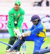 Mahela Jayawardene of Sri Lanka (R) is bowled by Johan Botha of South Africa