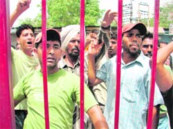 MC employees protest outside the police station in Moga on Thursday.