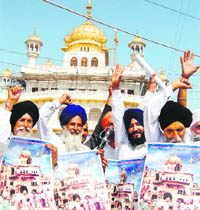 Members of radical organisations display pictures of Akal Takht, after Operation Bluestar, in Amritsar on Saturday.