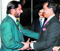 Pakistani Prime Minister Yousuf Raza Gilani (R) greets Shahid Afridi during a reception at The Prime Minister House in Islamabad.